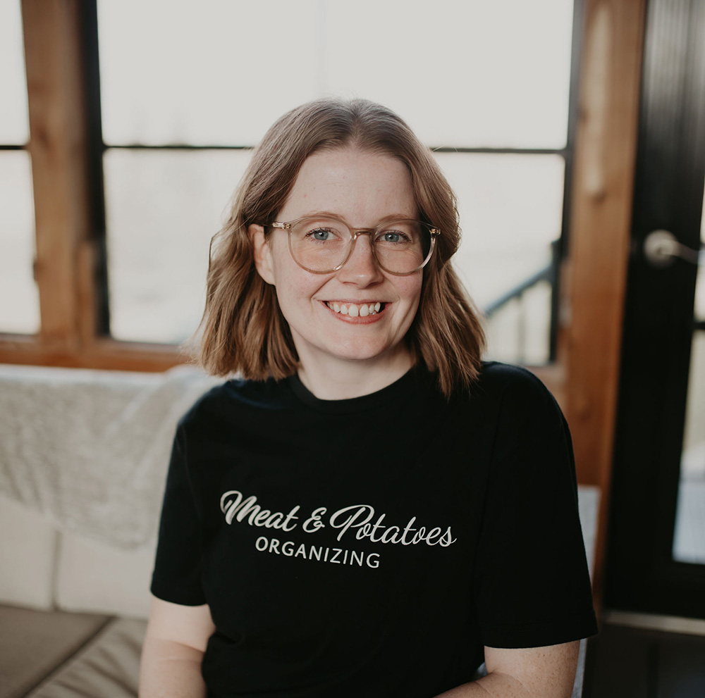 Bianca Singer, a professional organizer with Meat and Potatoes Organizing, working on organizing a space in the Twin Cities area. Specializes in decluttering, creating efficient storage solutions, and optimizing living and working spaces.