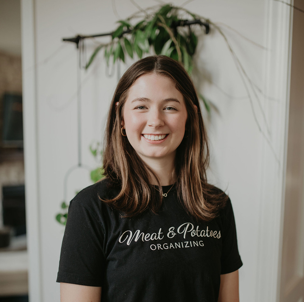 Erin Fortman, a professional organizer with Meat and Potatoes Organizing, organizing a space in Minneapolis, Minnesota. Expert in home organization, decluttering, and optimizing spaces for better functionality and ease.