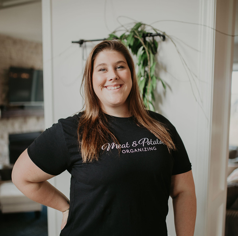 Jackie Leffner, a professional organizer with Meat and Potatoes Organizing, organizing a space in Lakeville, Minnesota. Expert in decluttering, creating functional storage solutions, and optimizing home and office spaces for greater efficiency.