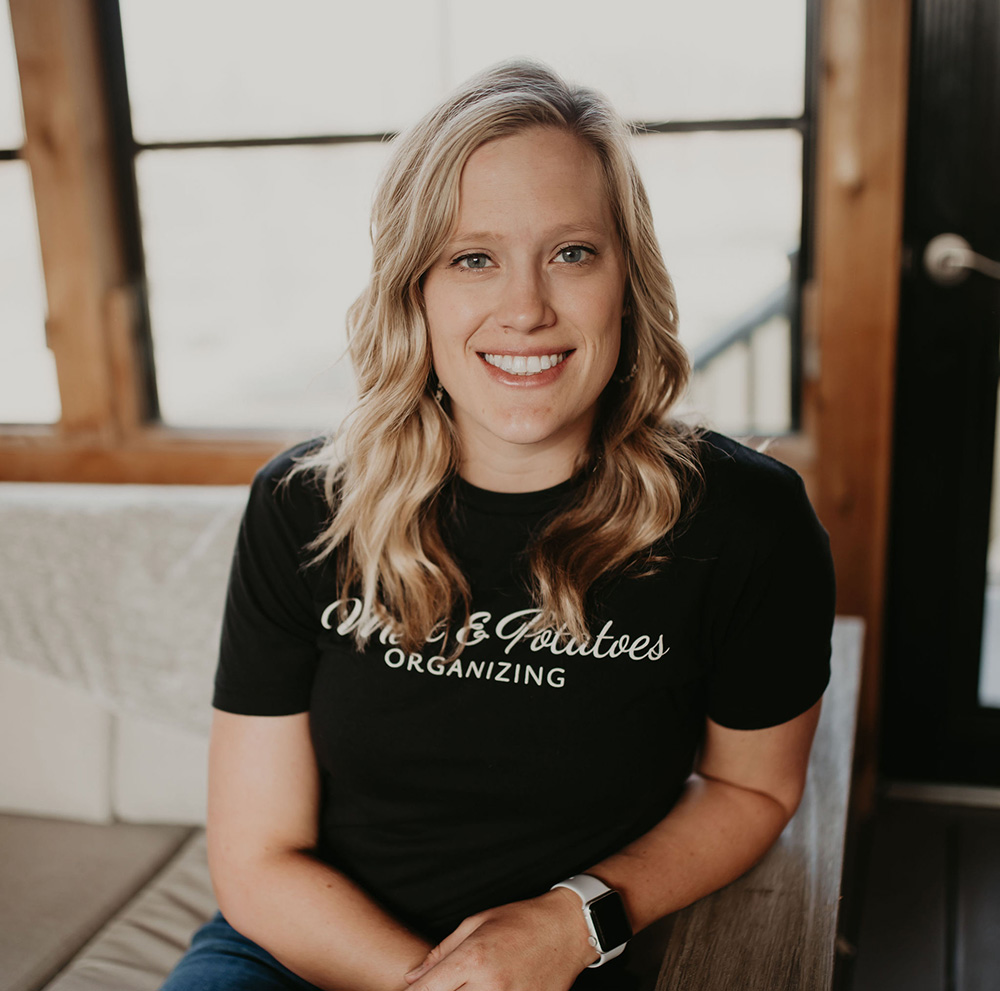 Melanie Peiffer, a professional organizer with Meat and Potatoes Organizing, assisting with organizing a space in Edina, Minnesota. Specializes in decluttering, home organization, and creating efficient, functional spaces tailored to clients' needs.