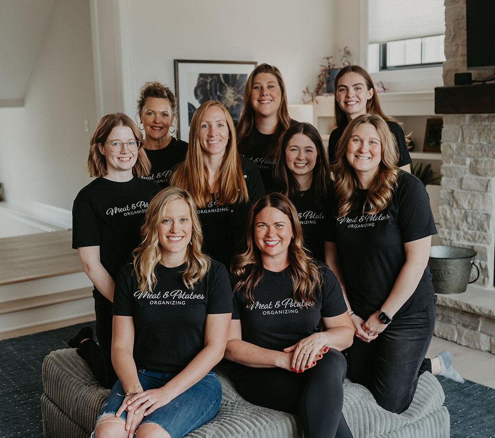 A professional organizing team from Meat and Potatoes Organizing in Saint Paul, Minnesota, efficiently decluttering and organizing a space. Specializing in creating functional systems for homes and offices, as well as providing expert packing and unpacking services.