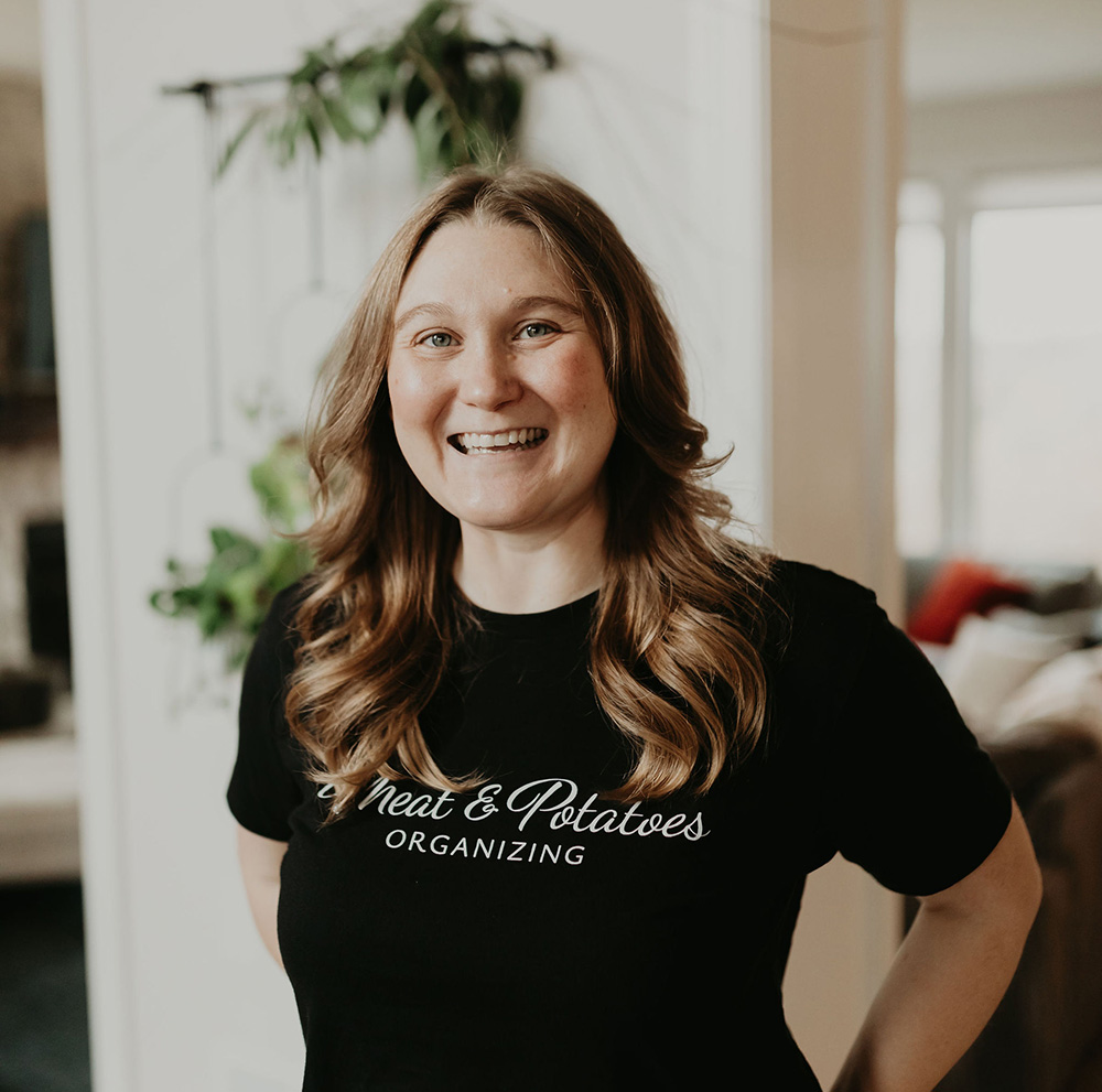 Sandra Johnson, a professional organizer, organizing a neatly arranged storage space in Lakeville. Expert in decluttering, home organization, and creating tailored solutions for efficient living and working environments.